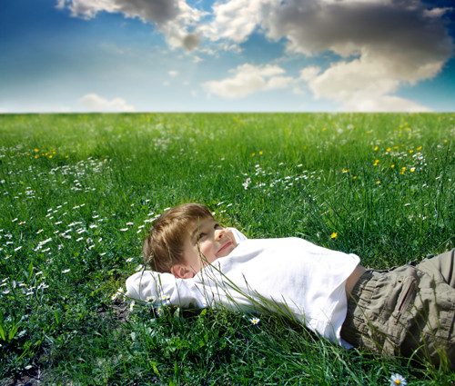 풀밭에 누워 상상하는 소년